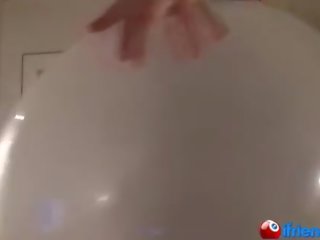 Damsel in black blows up giant balloon